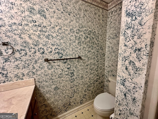 2409 Dorothy St, Waycross, GA 31501 - bathroom with baseboards, toilet, wallpapered walls, vanity, and tile patterned floors