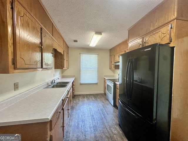 2409 Dorothy St, Waycross, GA 31501 - kitchen featuring freestanding refrigerator, a sink, stainless steel electric range oven, light countertops, and a textured ceiling