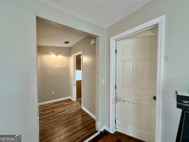 2409 Dorothy St, Waycross, GA 31501 - hall with dark wood-style floors, baseboards, and a textured ceiling