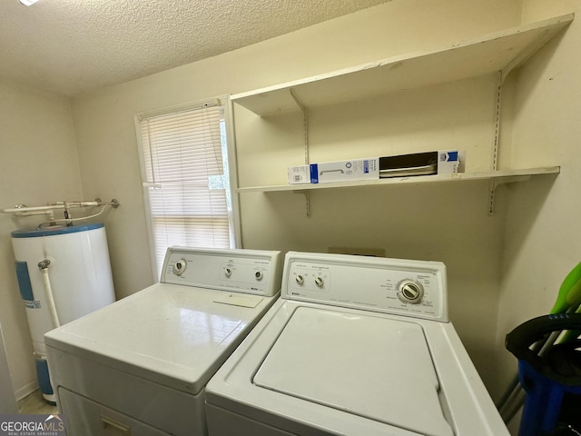 2409 Dorothy St, Waycross, GA 31501 - laundry area featuring washing machine and clothes dryer, a textured ceiling, and water heater