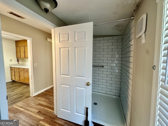 2409 Dorothy St, Waycross, GA 31501 - bathroom with a shower stall, wood finished floors, and baseboards