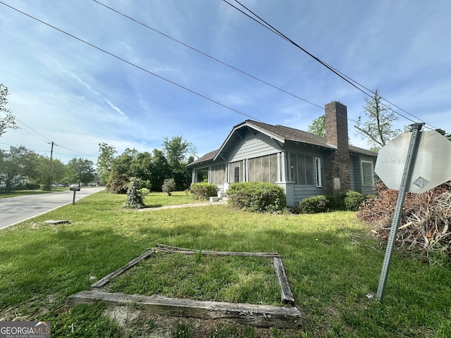2409 Dorothy St, Waycross, GA 31501 - view of property exterior with a chimney and a lawn
