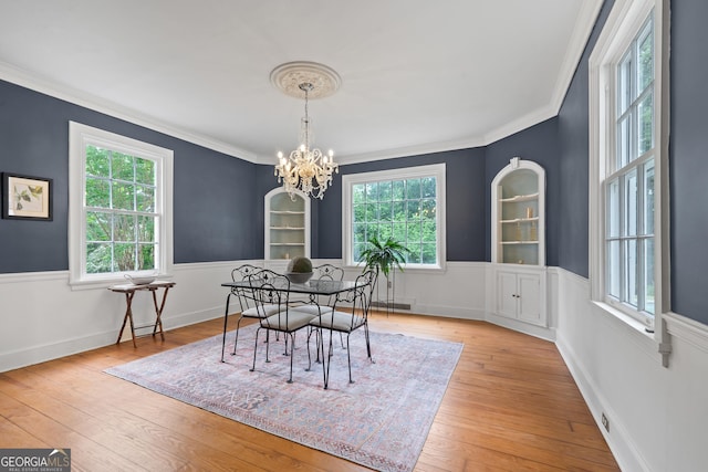 1419 Briarcliff Rd, Macon, GA 31201 - dining space with visible vents, crown molding, hardwood / wood-style flooring, and an inviting chandelier