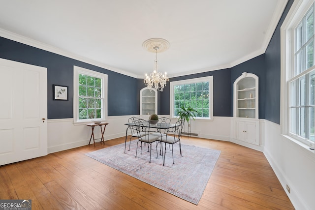 1419 Briarcliff Rd, Macon, GA 31201 - dining area with ornamental molding, an inviting chandelier, a healthy amount of sunlight, and light wood-style flooring