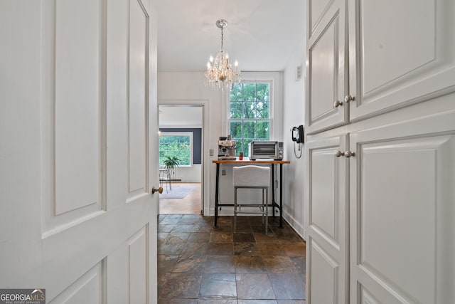 1419 Briarcliff Rd, Macon, GA 31201 - hall with stone tile flooring and a chandelier