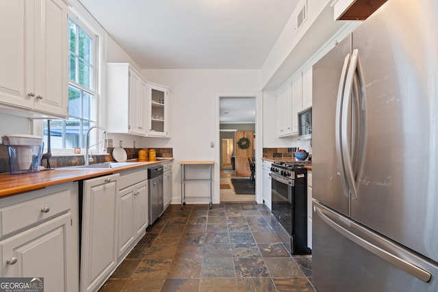 1419 Briarcliff Rd, Macon, GA 31201 - kitchen featuring white cabinets, visible vents, stainless steel appliances, and a sink
