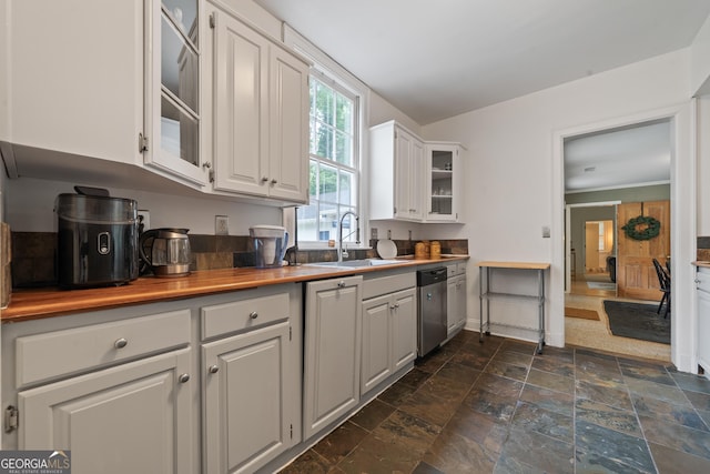 1419 Briarcliff Rd, Macon, GA 31201 - kitchen with white cabinets, stainless steel dishwasher, a sink, glass insert cabinets, and stone finish floor