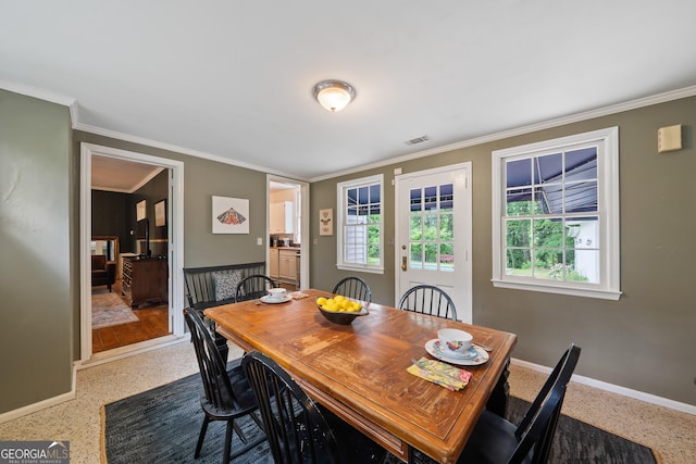 1419 Briarcliff Rd, Macon, GA 31201 - dining space with speckled floor, visible vents, crown molding, and baseboards