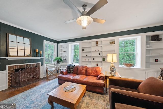 1419 Briarcliff Rd, Macon, GA 31201 - living room featuring wood finished floors, a brick fireplace, built in shelves, and ornamental molding