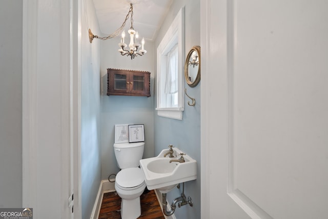 1419 Briarcliff Rd, Macon, GA 31201 - half bathroom with toilet, a notable chandelier, wood finished floors, and baseboards