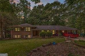 851 Rockbridge Rd SW, Lilburn, GA 30047 - rear view of house with a yard