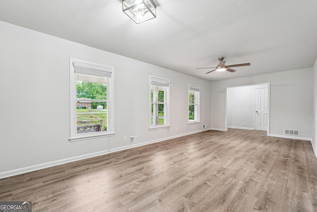 851 Rockbridge Rd SW, Lilburn, GA 30047 - empty room featuring visible vents, ceiling fan, wood finished floors, and baseboards