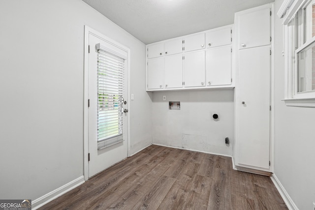 851 Rockbridge Rd SW, Lilburn, GA 30047 - clothes washing area with electric dryer hookup, cabinet space, washer hookup, and dark wood-type flooring