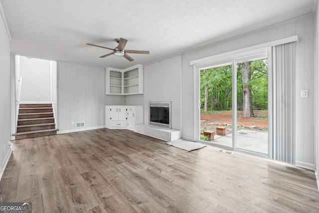 851 Rockbridge Rd SW, Lilburn, GA 30047 - unfurnished living room featuring ceiling fan, baseboards, wood finished floors, and visible vents