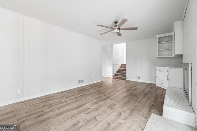 851 Rockbridge Rd SW, Lilburn, GA 30047 - unfurnished living room featuring stairs, visible vents, ceiling fan, and light wood-type flooring