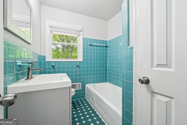 851 Rockbridge Rd SW, Lilburn, GA 30047 - bathroom with tile walls, vanity, toilet, visible vents, and  shower combination