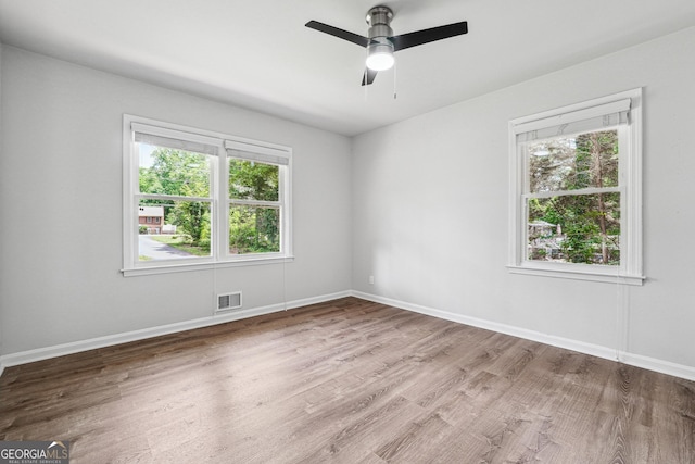 851 Rockbridge Rd SW, Lilburn, GA 30047 - unfurnished room with visible vents, wood finished floors, and baseboards