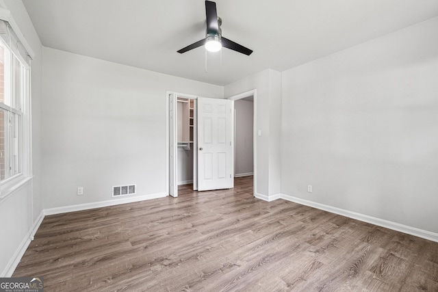 851 Rockbridge Rd SW, Lilburn, GA 30047 - unfurnished bedroom with visible vents, a closet, baseboards, wood finished floors, and a ceiling fan