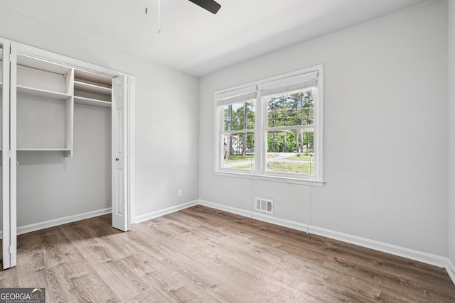 851 Rockbridge Rd SW, Lilburn, GA 30047 - unfurnished bedroom with wood finished floors, visible vents, and baseboards