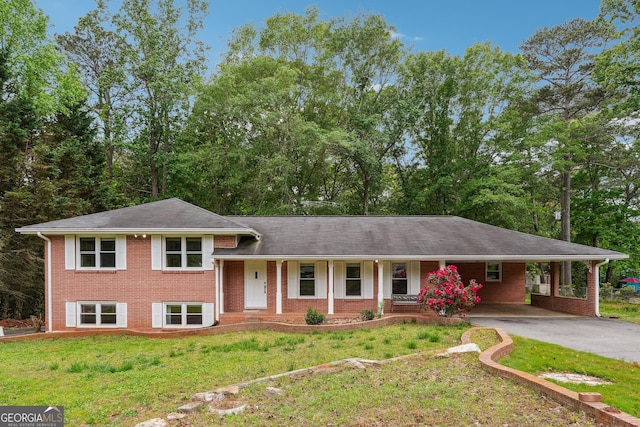 851 Rockbridge Rd SW, Lilburn, GA 30047 - tri-level home featuring concrete driveway, a front lawn, and brick siding