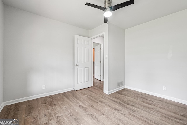 851 Rockbridge Rd SW, Lilburn, GA 30047 - unfurnished bedroom featuring baseboards, visible vents, wood finished floors, and a ceiling fan