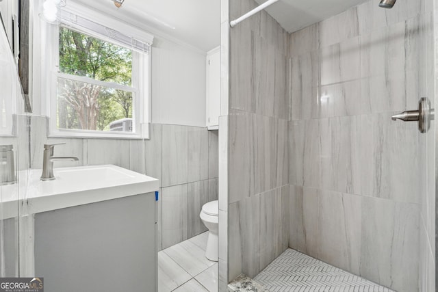 851 Rockbridge Rd SW, Lilburn, GA 30047 - bathroom featuring tile walls, tiled shower, vanity, toilet, and crown molding