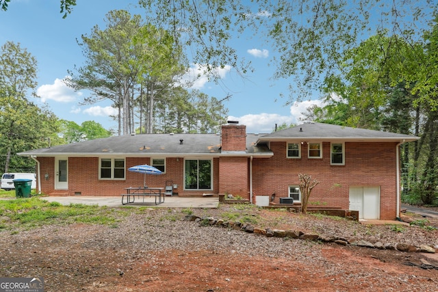 851 Rockbridge Rd SW, Lilburn, GA 30047 - back of house with a chimney, brick siding, and a patio area