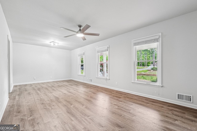 851 Rockbridge Rd SW, Lilburn, GA 30047 - unfurnished room featuring visible vents, ceiling fan, a wealth of natural light, and light wood-type flooring
