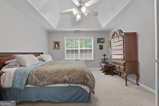 bedroom with baseboards, a raised ceiling, a ceiling fan, and carpet flooring
