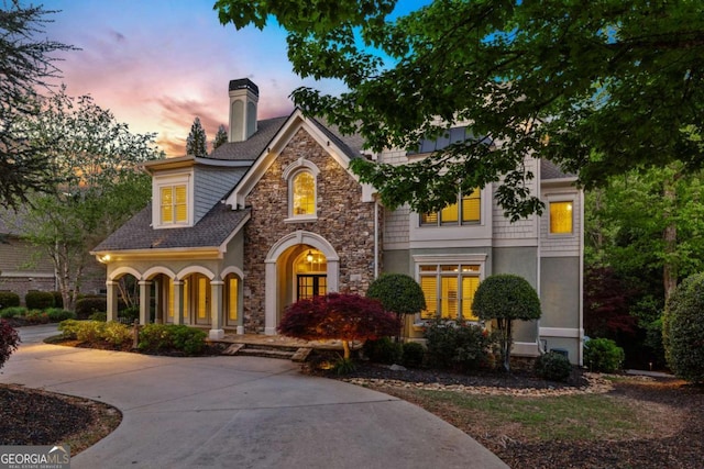2480 Flint Creek Dr, Cumming, GA 30041 - view of front of home with a chimney, stone siding, and a shingled roof