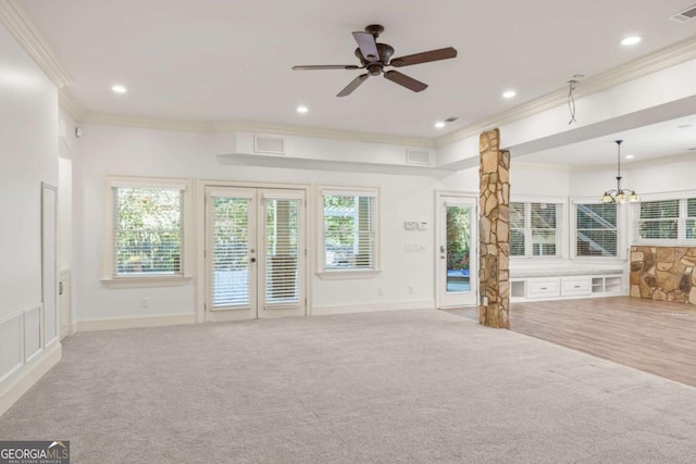 2480 Flint Creek Dr, Cumming, GA 30041 - unfurnished living room featuring a wealth of natural light, crown molding, carpet flooring, and french doors