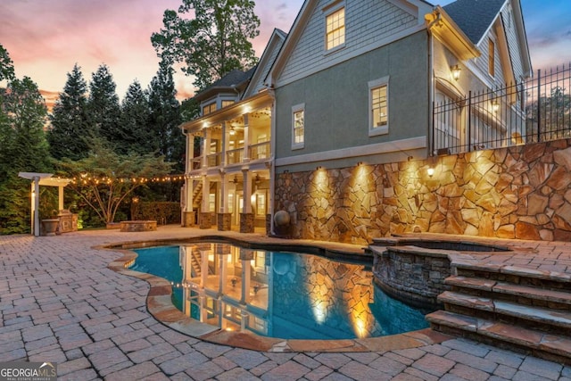 2480 Flint Creek Dr, Cumming, GA 30041 - pool at dusk with an outdoor pool, a patio, and an in ground hot tub