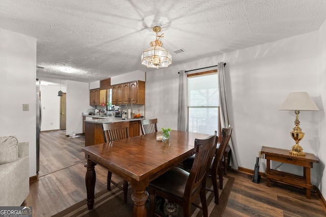 4701 Cleveland Hwy, Gainesville, GA 30506 - dining space with a textured ceiling, dark wood-type flooring, a chandelier, and baseboards