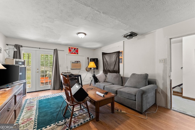 4701 Cleveland Hwy, Gainesville, GA 30506 - living room featuring wood finished floors, french doors, a textured ceiling, and a wall mounted air conditioner