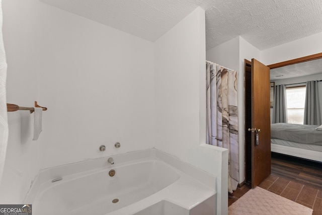 4701 Cleveland Hwy, Gainesville, GA 30506 - ensuite bathroom featuring a garden tub, wood finished floors, and a textured ceiling