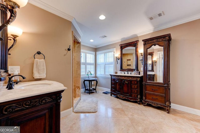 bathroom with ornamental molding, a sink, baseboards, and visible vents