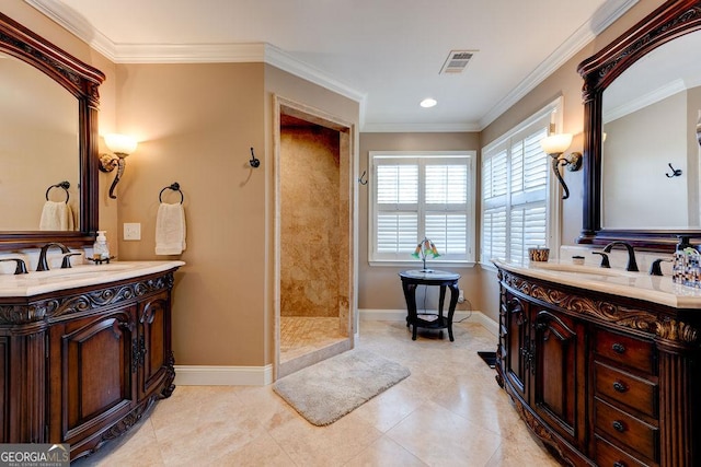 bathroom featuring visible vents, two vanities, a tile shower, and a sink