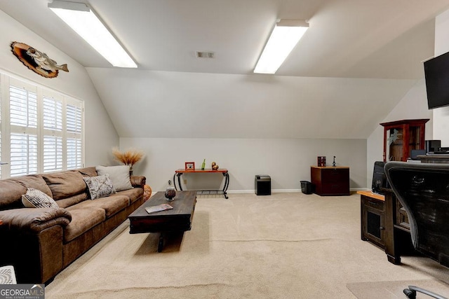 office featuring light colored carpet, visible vents, lofted ceiling, and baseboards