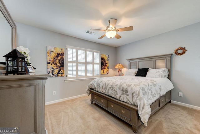bedroom with baseboards, visible vents, ceiling fan, and light colored carpet