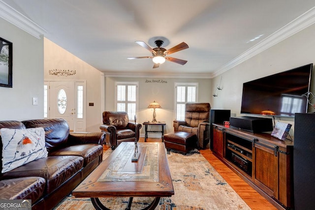 living area with a ceiling fan, light wood-style floors, and crown molding