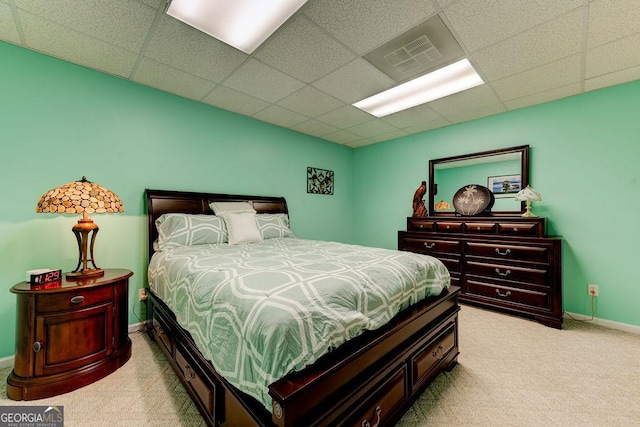 bedroom featuring visible vents, carpet floors, and a paneled ceiling