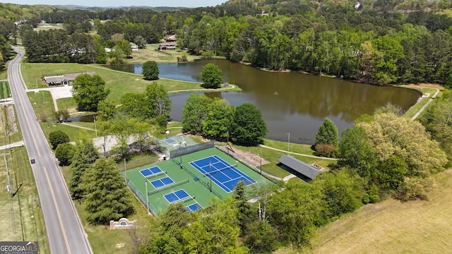 bird's eye view with a wooded view and a water view