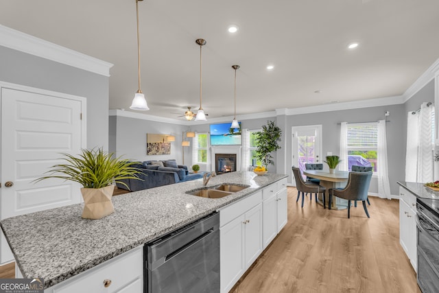 kitchen with crown molding, a sink, a glass covered fireplace, electric stove, and stainless steel dishwasher