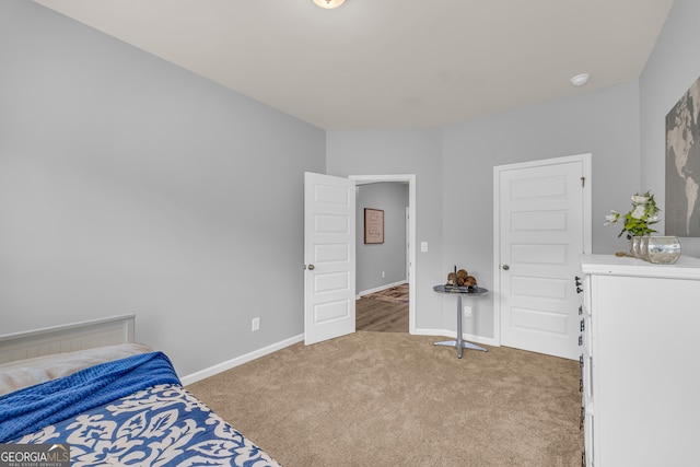 bedroom featuring baseboards and carpet