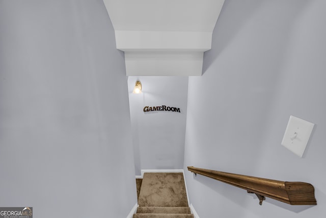 stairway with baseboards and carpet