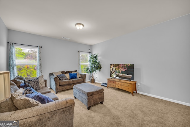 carpeted living room with visible vents and baseboards