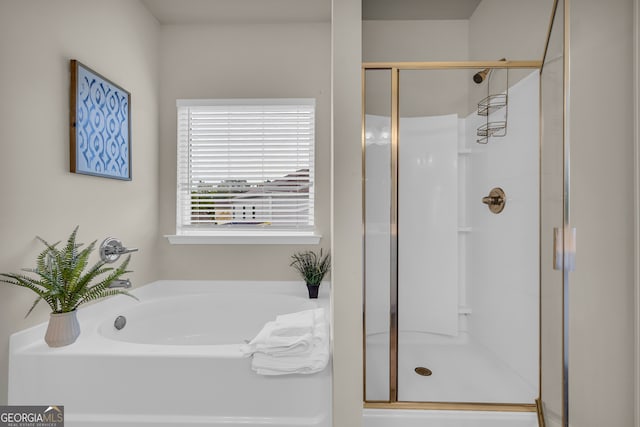 full bathroom featuring a shower stall and a bath