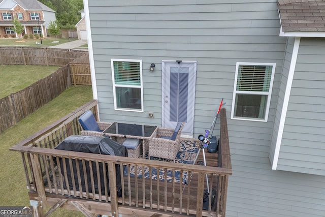 deck featuring a fenced backyard and a lawn