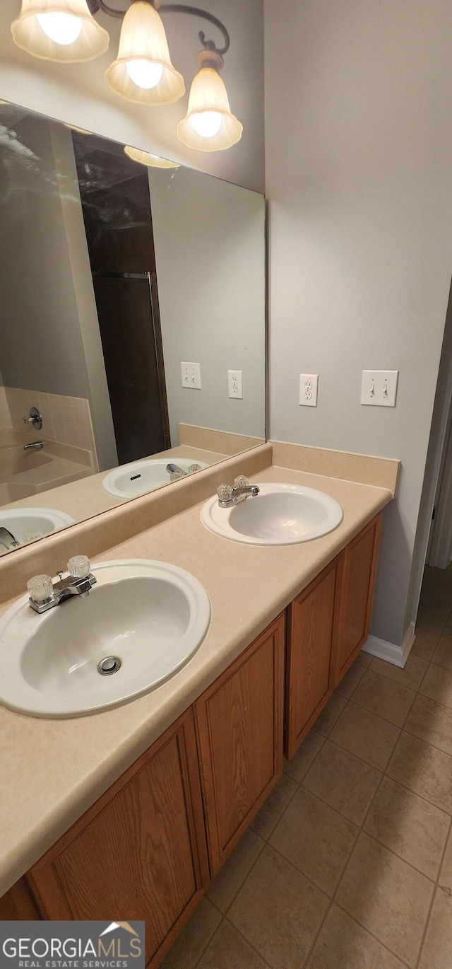 bathroom featuring double vanity, a sink, and tile patterned flooring