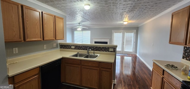 kitchen featuring a sink, light countertops, black dishwasher, a peninsula, and a ceiling fan